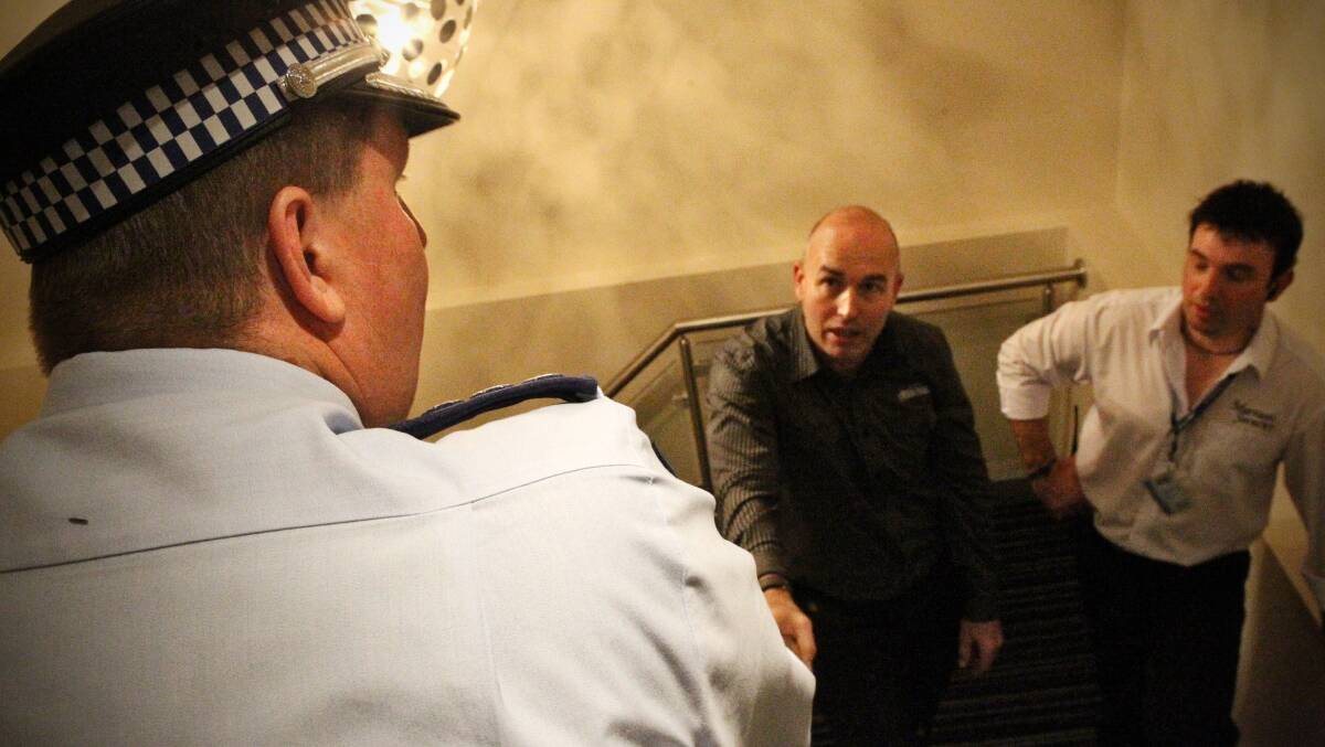COMPLY: Venue manager Brendon Cooper, pictured in a staircase with police in 2011. He said the pub was fully complying with officers. 