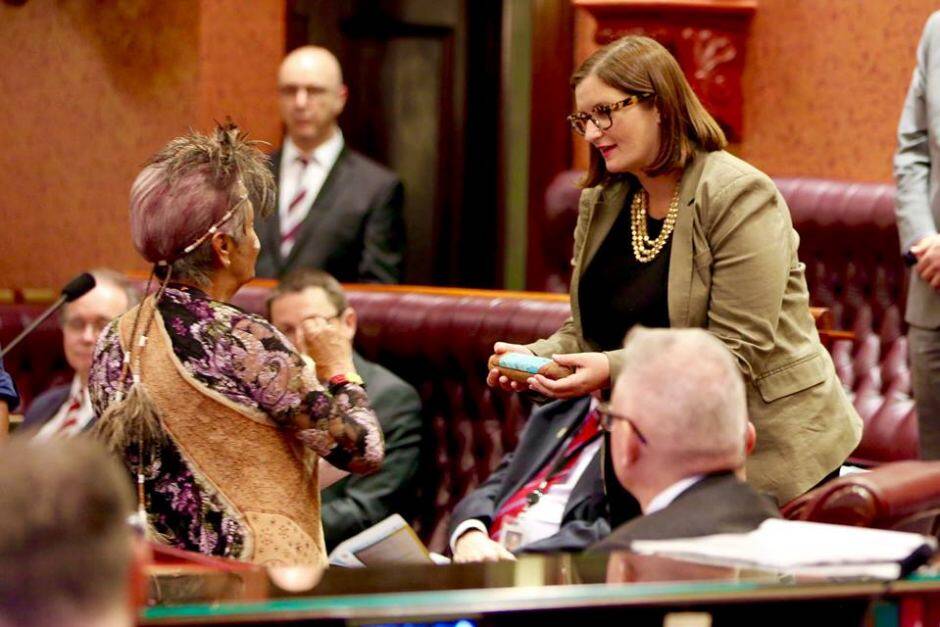 The handing of the Message Stick to Aboriginal Affairs minister Sarah Mitchell.