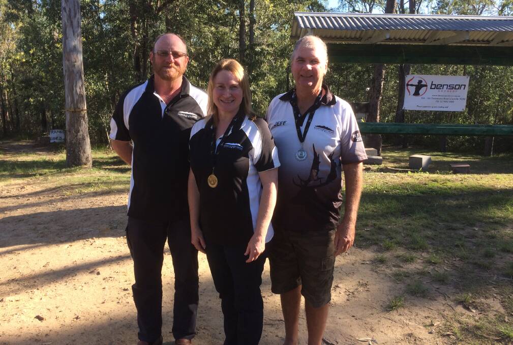 Champion: Evette Terres (centre), husband Lamont Terres (left) and coach Jeff Jennings represented Gloucester District Archers at the event. 