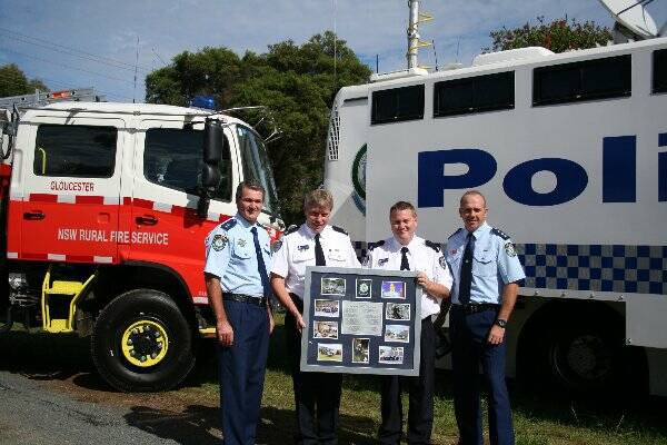 • Superintendent Paul Fehon and Detective Inspector Peter Mckenna present Rural Fire Service operations officer Inspective Dave Millsteed and Inspector Andrew Brown with a series of photos from Strike Force Durkin’s presence in Gloucester