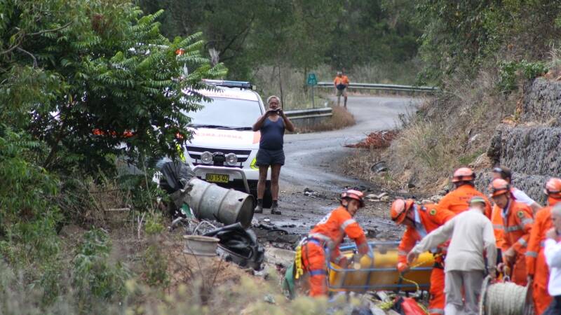 Emergency services at the scene of a two-truck crash on the Thunderbolts Way north-west of Gloucester this afternoon.