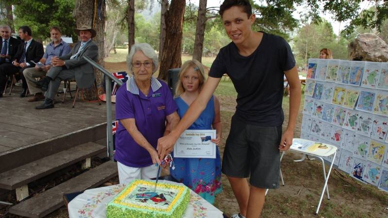 Norma Fisher, Anita Jackson and Jack Wilson cut the Australia Day cake.