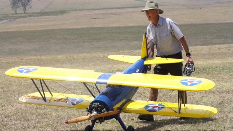 Peter Coles with the model biplane he built.