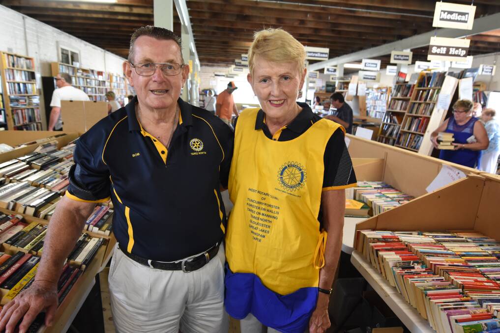 Books and more: Members of Taree North Rotary Club Bob Coleman and Jan Swift during last year's Monster Easter Book Fair. It's on again this Friday to Sunday at Taree Showground.