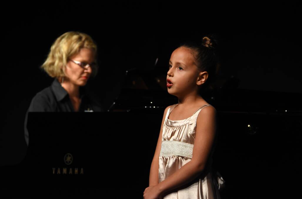 Eight years and under: Ruby Hann from Forster Tuncurry, accompanied by pianist Lydia Wills.