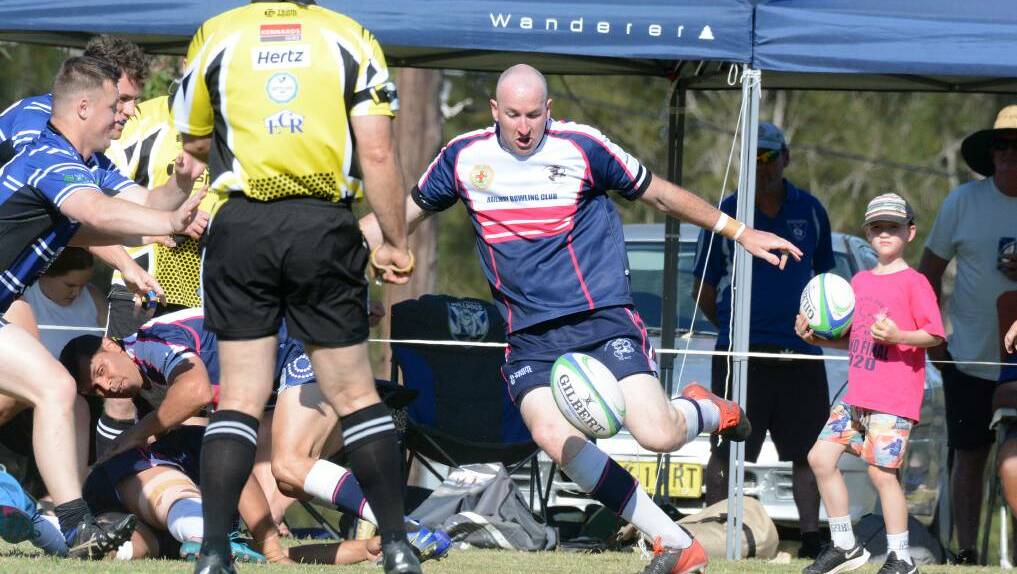 Ricky Campbell from the Ratz puts boot to ball during the 2020 grand final against Wallamba. The Ratz won the game.