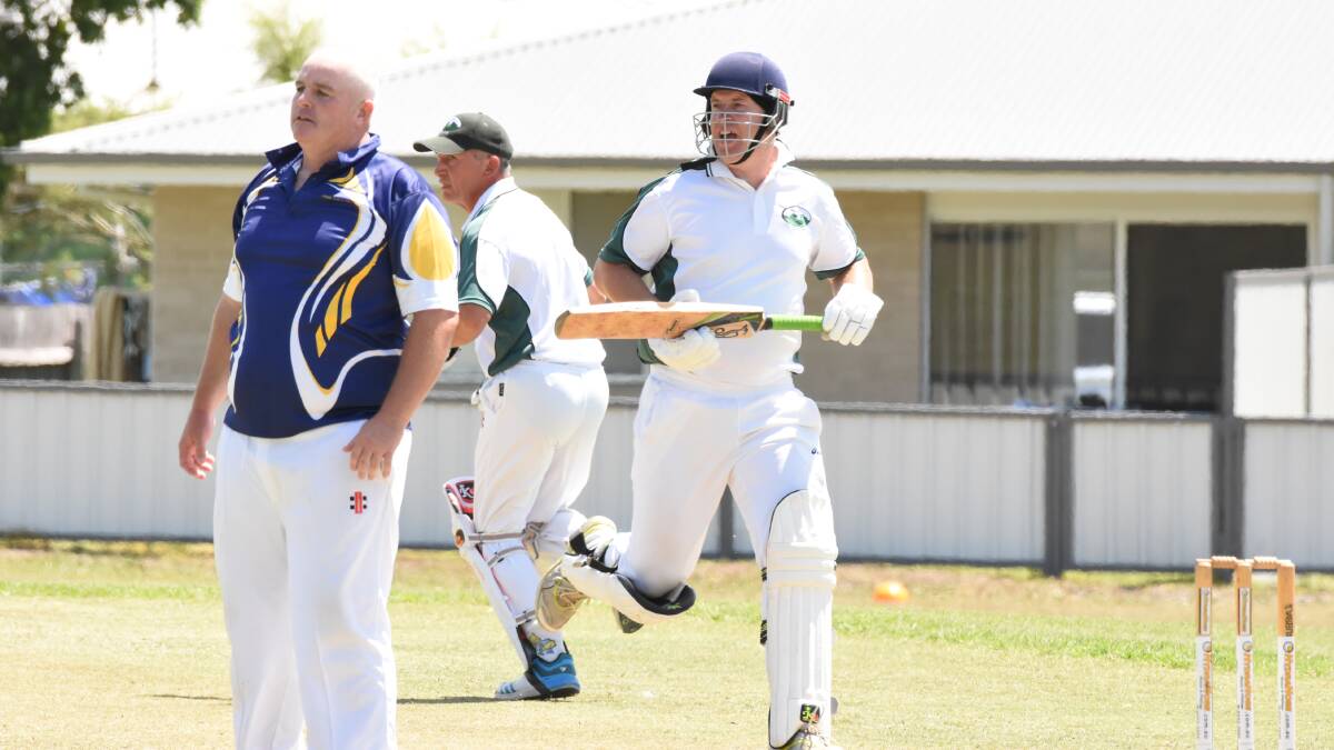 Gloucester batsmen Adam Cameron and Darren Yates cross for a run during the Mid North Coast over 35 cricket final played at Taree last month.