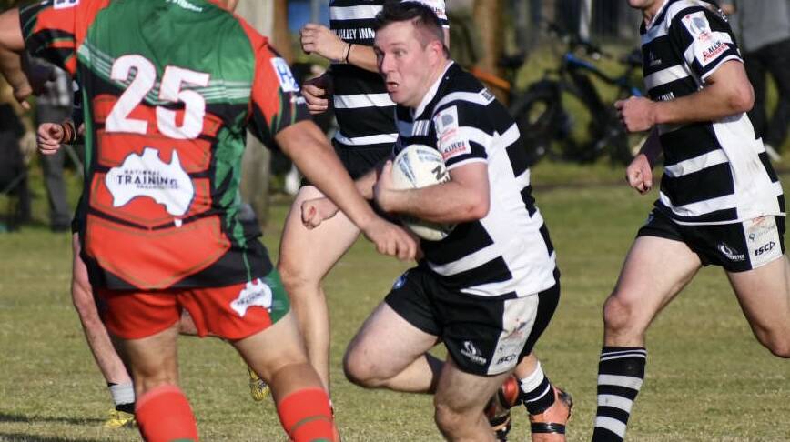 Andrew Middlebrook takes the ball forward for the Magpies.