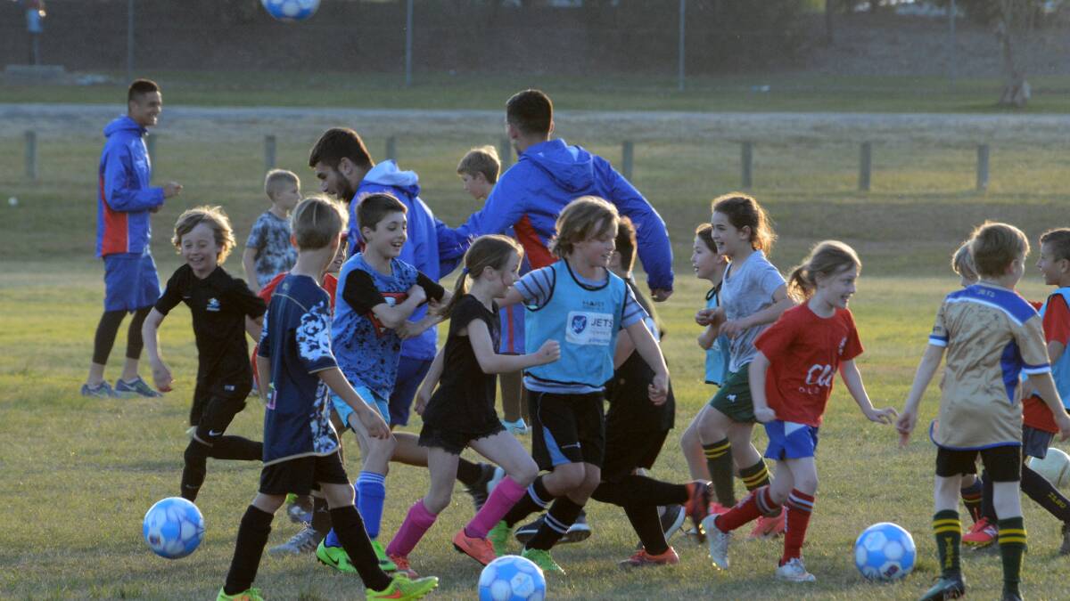 Newcastle Jets stars at a coaching clinic at Taree's Omaru Park last year. The players will conduct a clinic and a meet and greet at Boronia Park at Forster next Monday.