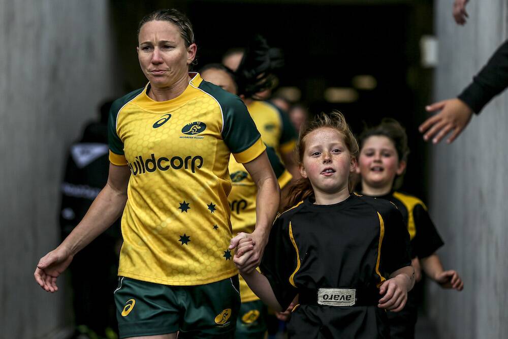 Vincentia's Ash Hewson leads the Wallaroos onto the field during her playing career. Photo: Supplied