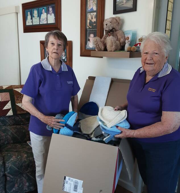 Gloucester Quota Club members Claire Reynolds and Margaret Andrews boxing up the beanies and scarves. Photo supplied