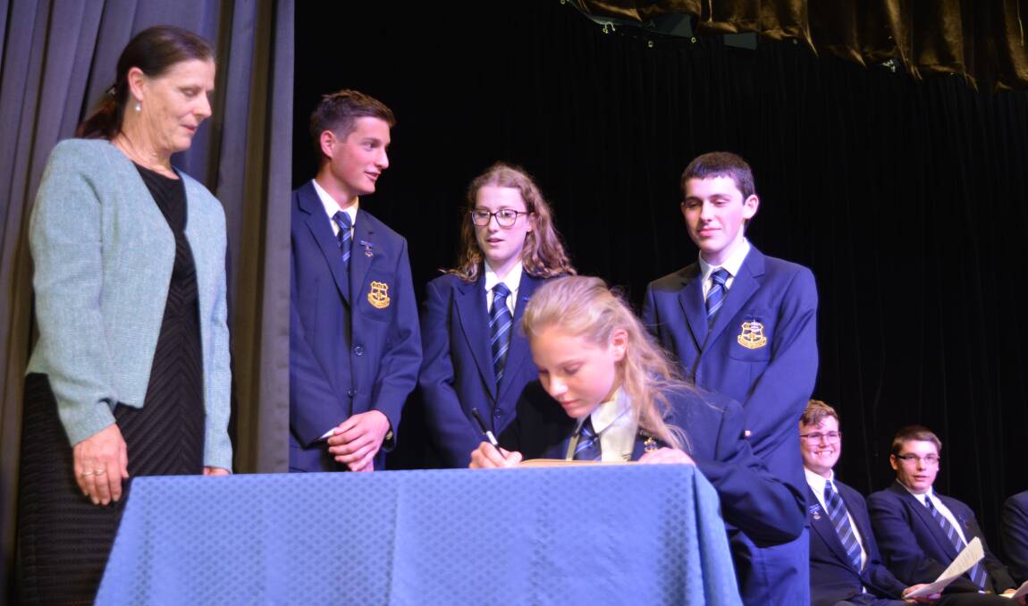 In a tradition that has been going on since 1964, the new captains and vice captains sign their names in the book. 
