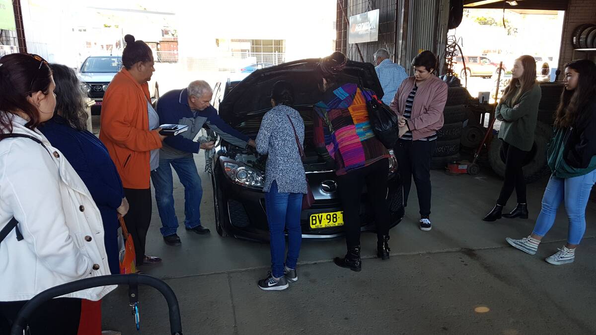 CWA Young Women's group gets a few tips on how to check the oil at Gloucester Tyre and Battery Service. Photo supplied
