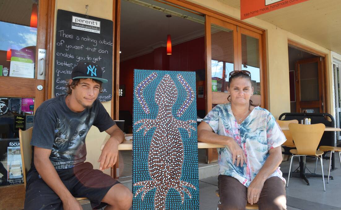 Jack Wratten and Gai Clarke have their traditional Aboriginal dot paintings on display at Perenti cafe. Photo Anne Keen 
