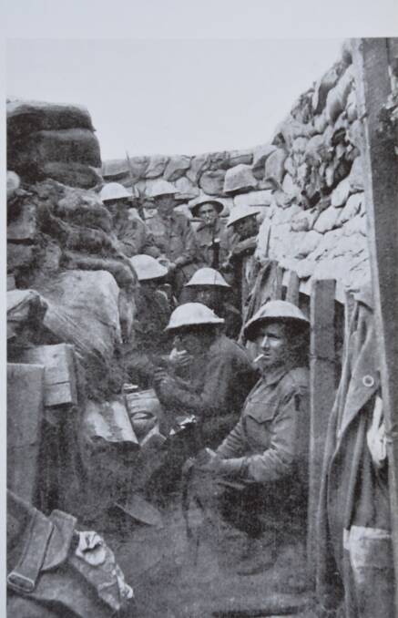 Soldiers from the 53rd Battalion enjoy a last smoke before donning their gear to 'hop the bags' at Fromelles. Of the eight men shown, five will be killed and the other three wounded. Picture. The Anzacs Gallipoli to the Western Front.