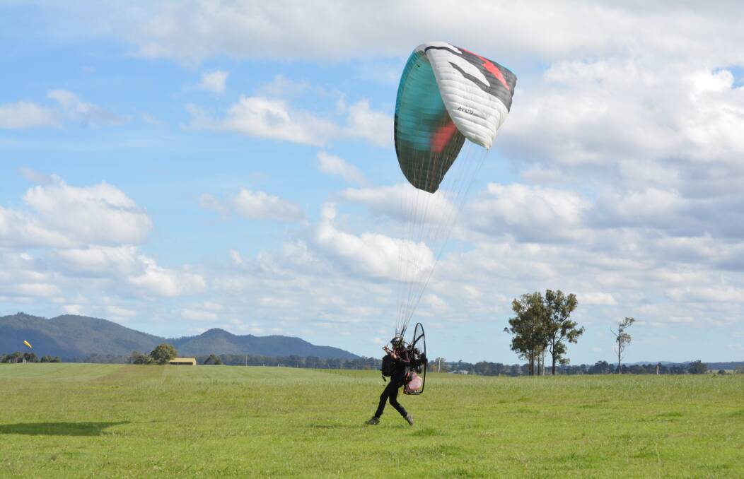 Paramotoring pilot taking off from Gloucester airfield