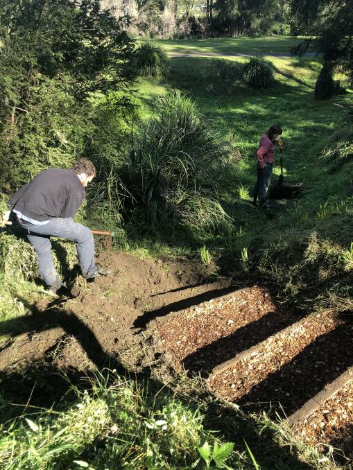 Volunteers work to repair the stairs at Minimbah Gardens. Photo supplied