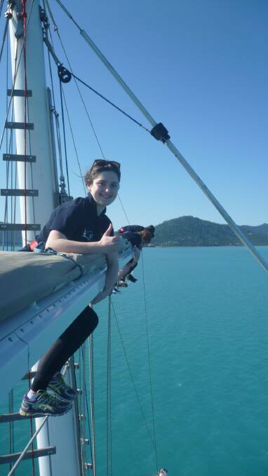 Upwards and onwards: Hayley Johns during one of her journey's up the mast while sailing around the Whitsunday Islands. Photo supplied.