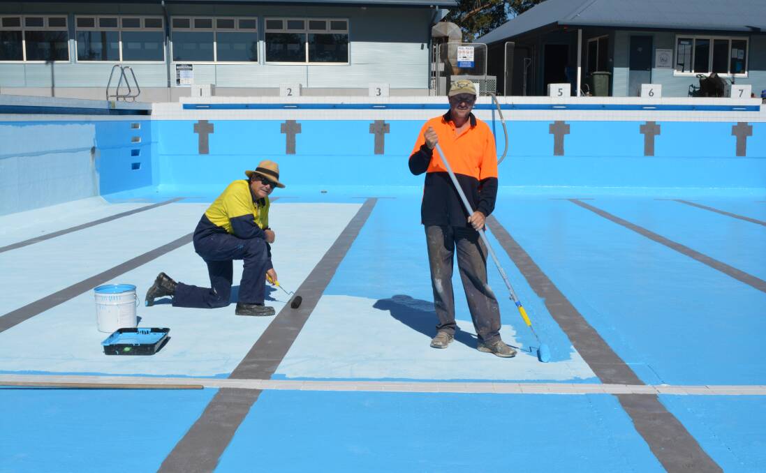 MidCoast Council pool staff, David Windred and Leigh Treson hard at work painting the Gloucester pool ahead of the summer swim season. Photo Anne Keen