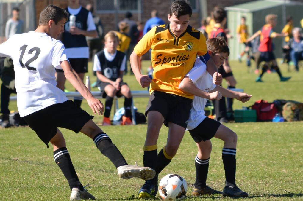 Aiden Hawkins and Lane Edwards fight hard to take possession of the ball. Photo supplied