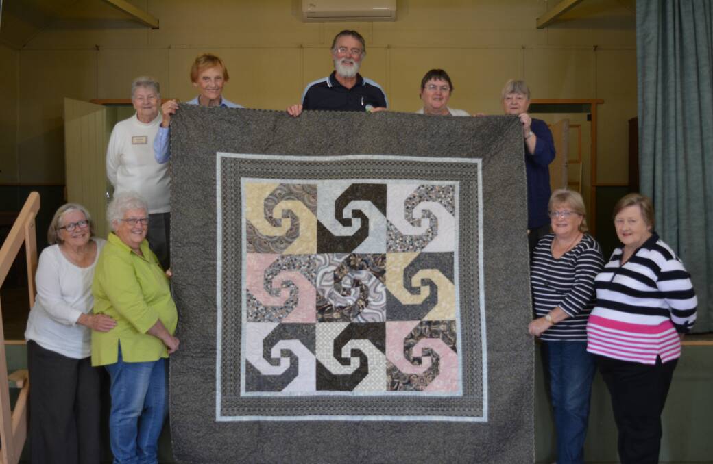 Gloucester Patchwork Group donate a quilt to Ian Parks' fundraiser for cancer research. 