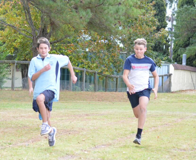 12 years male runner up Ethan Osborne and champion Zac Schafer during the 100 metre dash 