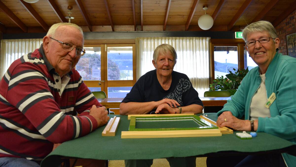 Serious business: Barry Frew, Pat Frude and Clare Frew have an empty spot at their table for anyone interested in playing mahjong. Pat has been a member since the group began, while Barry and Clare joined in 2010. Photo: Anne Keen 