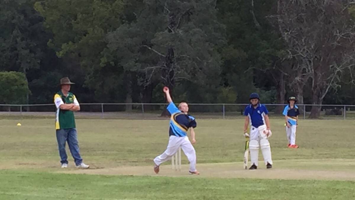 Wyatt Griffin bowling. Jackson Moore in the field and parent volunteer, Mark Edwards umpiring during game against Bulahdelah Central School. Photo supplied