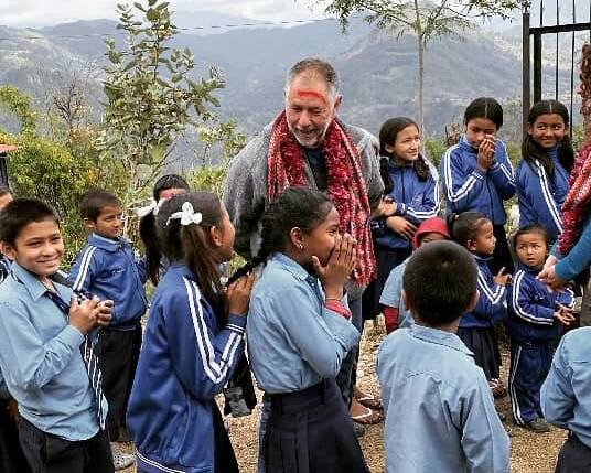 Allan Waldon with some school children during a visit to Nepal. Photo supplied