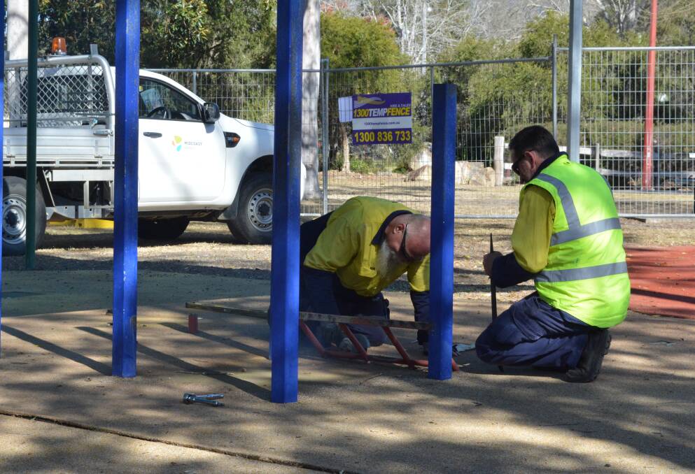 MidCoast Council staff get to work on the existing playground equipment. Photo Anne Keen