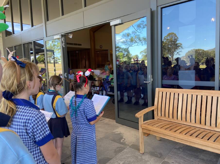 Mirrabooka residents stayed COVID-safe inside the building while the children sang.