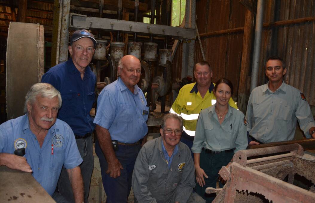 Good as new: Members of the Hunter Valley Vintage Farm Machinery Club with NPWS staff Coralie De Angelis and Anthony Signor and the refurbished stamper machine. Photo Anne Keen