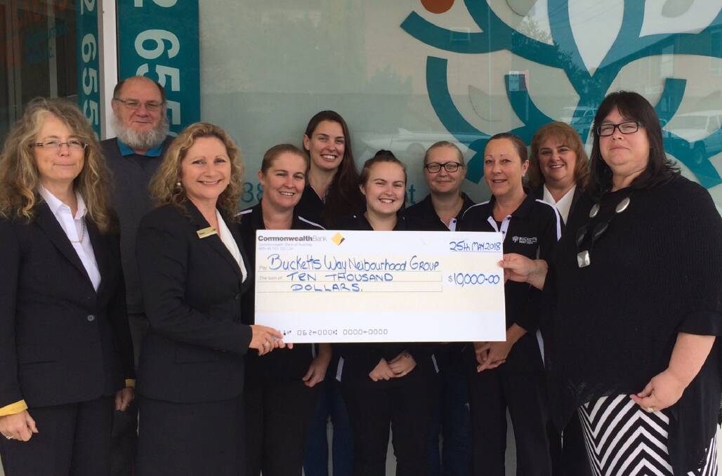 Staff from the Bucketts Way Neighbourhood Group and the Commonwealth Bank Gloucester branch with a big cheque for $10,000. Photo supplied.