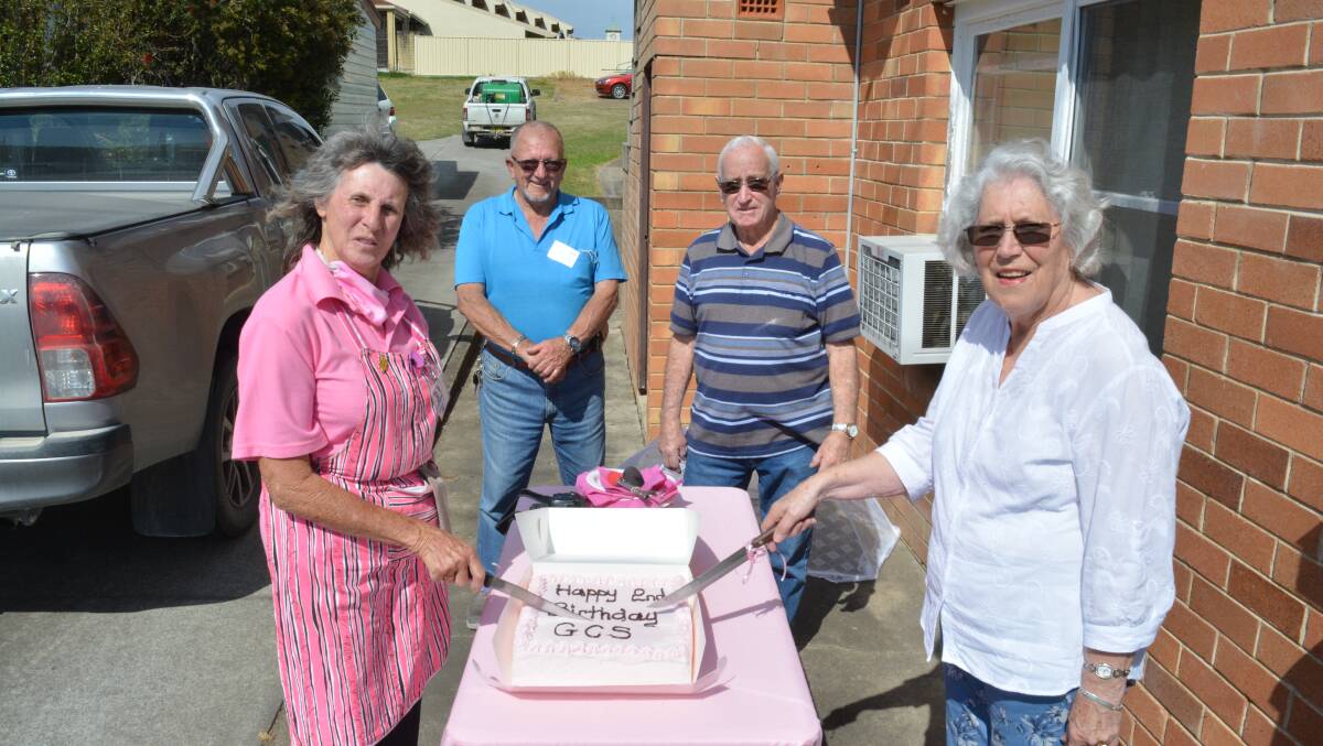 Di Relf, Cedric Salter, Doug and Judith Pittman cut of Gloucester Community Shop birthday cake. 