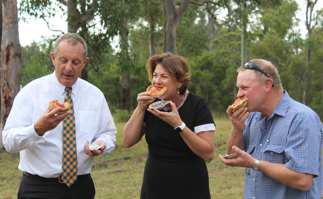 Celebrating success: Michael Johnsen, Melinda Pavey and Rod Williams enjoy a pie after the announcement on the Bucketts Way south of Gloucester. Picture: Supplied