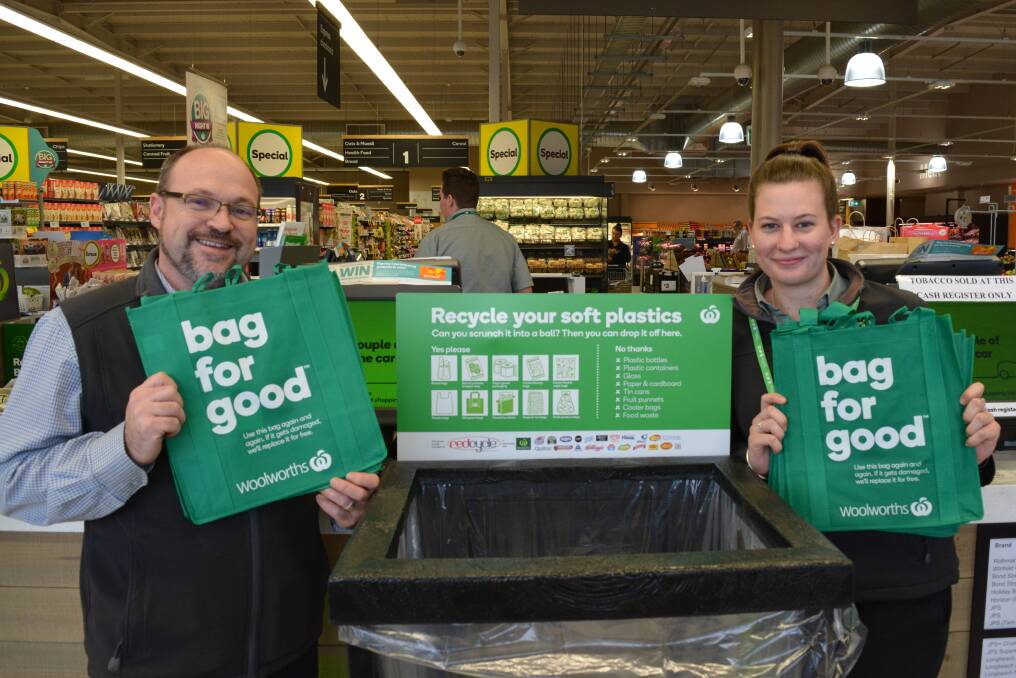Glenn McCormack and Meegan Johnson from Gloucester Woolworth with the new green bags and the REDcycle bin. Photo Anne Keen