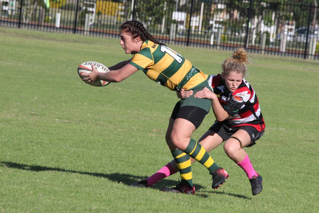 Determination: Gloucester Cockies Taylor Scanlon goes in for the tackle during the game against the Tuncurry Dolphinettes. Photo: Kirsten Jory