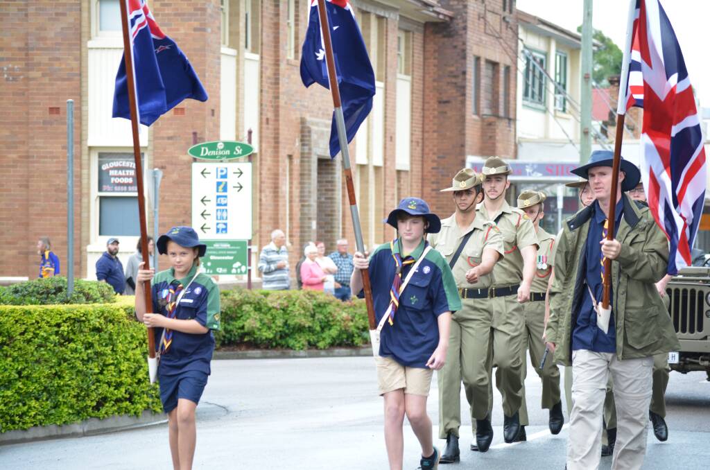 Gloucester's Scout Club members, Abbigale Sterling, Drew Gorton and Adam Glew lead the march down Church Street. Photo Anne Keen