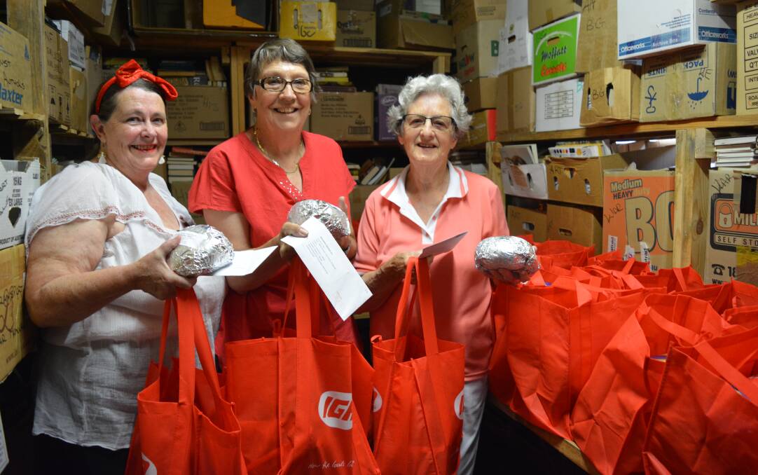 The bags are packed: Deborah Brooks, Ronda Teece and Helen Parsons after finishing off the hampers for people to collect. Photo: Anne Keen