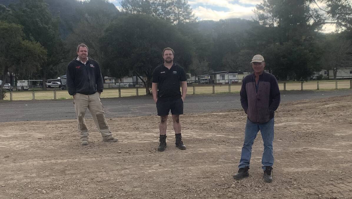 Frank Compton (secretary), Craig Murray (coach) and Kenneth White (president) stand on the future spectator mound. Photo Rodney Summerville.