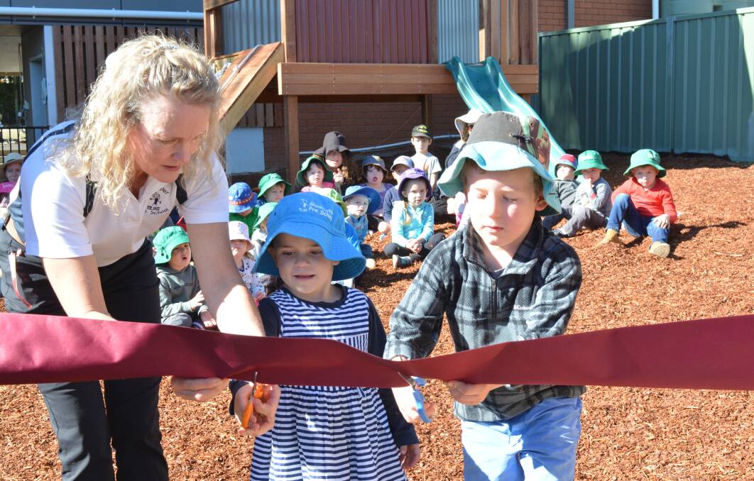 Elizabeth Price helps student Kyiesha Oestmann cut the ribbon alongside fellow student Spence Haschek at the officiale opening in May 2018. Photo Anne Keen