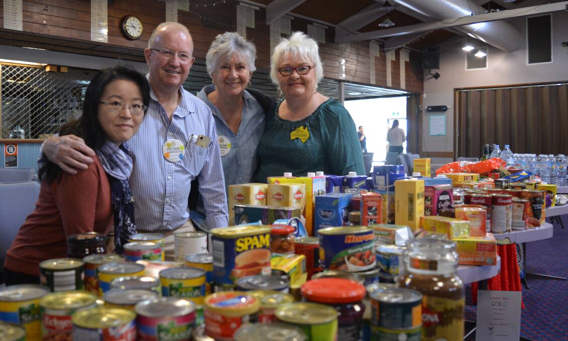 Gloucester Rotary Club members Li Meng Wong, Peter Markey, Valda Barron and Ashleigh Hickman with the food donated by Forster Bowling Club members.