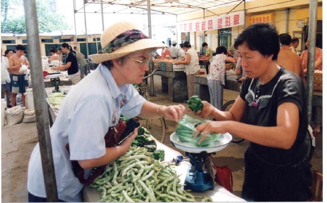 Kerry bartering in the shopping market at Xingcheng in 2001.