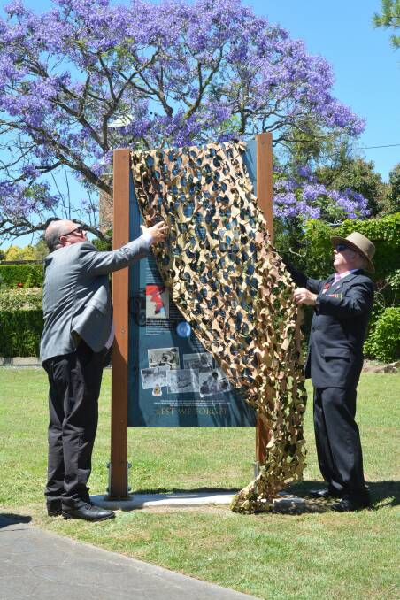 Neil Whipp and Frank McGovern unveil the Korean War plaque in Gloucester Memorial Park.