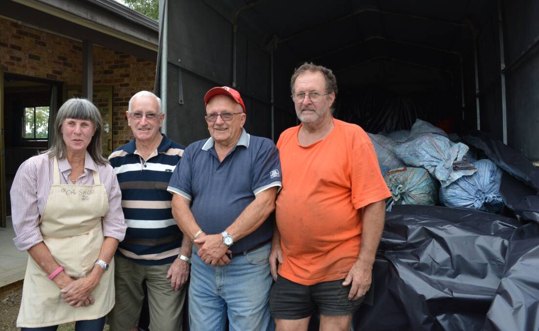 Getting dirty: Di Relf, Doug Pittman, Cedric Salter and Robert Abbott are part of the group of volunteers who pitched in to get the load on the road. Picture: Anne Keen  