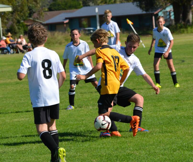 Jack Bignall goes in for the tackle during the u13s game against the Tuncurry Tigers. Photo supplied