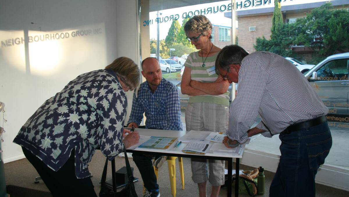 Helping Hand: Energise Gloucester committee members Stephan Pfister and Pat Burrows help sign up new members during the meeting. Picture: Anne Keen