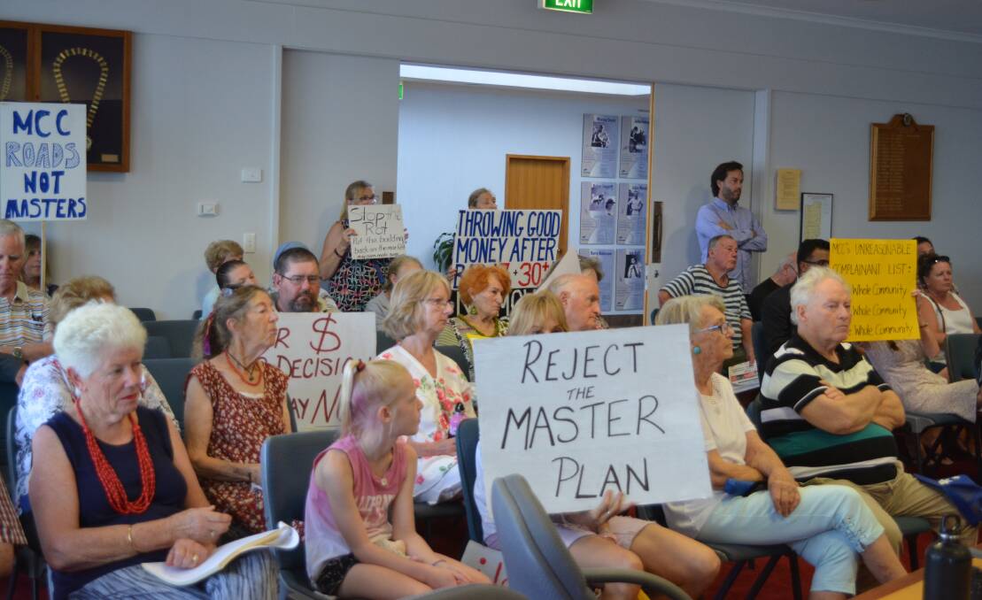 Some of the group carried their protest signs into the council meeting. Photo Anne Keen