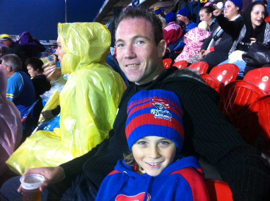 A day out with Dad: Derek Kerry and his son Riley enjoy a game at MacDonald Jones Stadium watching a Newcastle Knights game not long before his death. Picture supplied