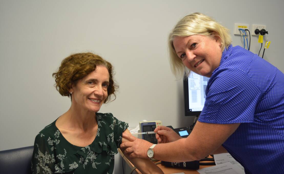 Dr Michele Hogg received the first COVID-19 vaccination in Gloucester by registered nurse Sue Wallace.
